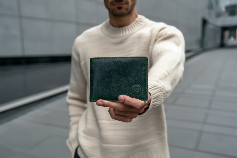 male model holding green genuine leather wallet